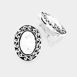 Clip on 1" small silver hammered oval earrings with flower design edges